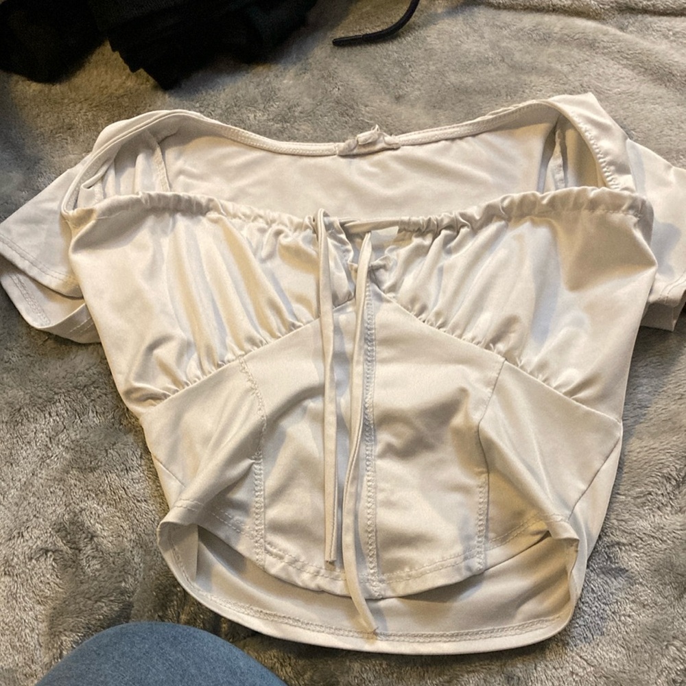 White shirt, crop, and ties between top of boobs.